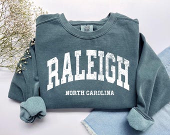 Raleigh North Carolina Sweatshirt: Distressed Retro College Crewneck