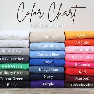 May include: A color chart for Gildan 18000 apparel, featuring a variety of colors. The chart displays folded fabric samples in shades like white, ash, sport gray, dark heather, and black. Other colors include Irish green, navy, and purple.