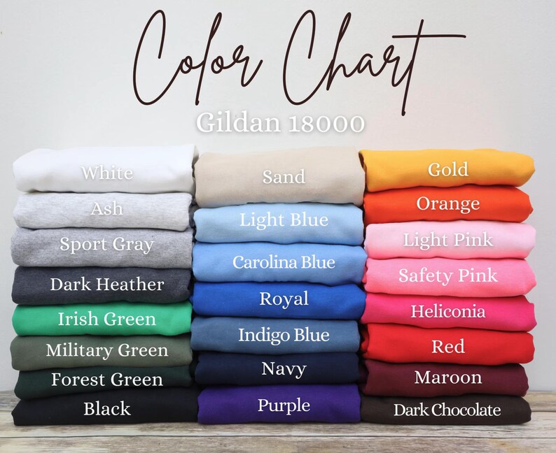 May include: A color chart for Gildan 18000 apparel, featuring a variety of colors. The chart displays folded fabric samples in shades like white, ash, sport gray, dark heather, and black. Other colors include Irish green, navy, and purple.
