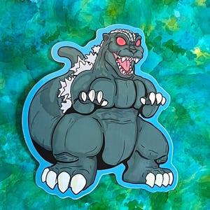 May include: A cartoon sticker of a green Godzilla-like monster with red eyes and white teeth. The monster is standing on its hind legs with its arms raised in a threatening pose.