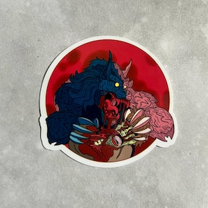 May include: A sticker featuring a blue werewolf with glowing yellow eyes biting into a pink creature with multiple eyes. The background is a red circle.