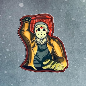 May include: A sticker featuring a cartoon illustration of a masked horror character holding a bloody machete. The character is wearing a brown jacket and a white hockey mask with a red triangle on the forehead. The background is a gray speckled surface.