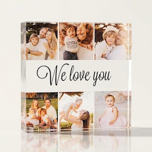May include: A clear acrylic photo block featuring multiple family photos. The block has a white banner with the text "We love you" in elegant script. The photos depict various family members in different settings.