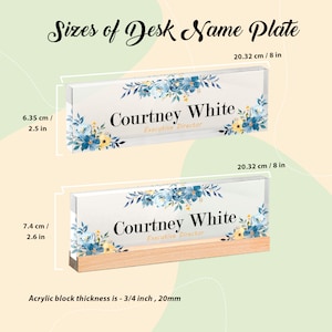 May include: Two desk name plates with floral designs and the name "Courtney White, Executive Director." The top plate is 8 inches long and 2.5 inches tall. The bottom plate is 8 inches long and 2.6 inches tall, with a wooden base. Acrylic block thickness is 3/4 inch.