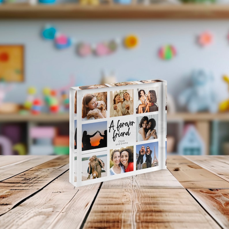 May include: A clear acrylic photo block featuring nine images of friends. The block has the text "A forever friend" with the names Olivia and Emma. The photos are of people, and the block is on a wooden surface.