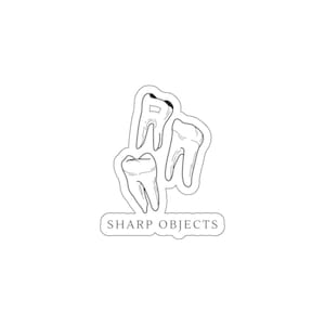 May include: A die-cut sticker featuring a black and white line art illustration of three human teeth arranged in a cluster. Below the teeth, a rectangular speech bubble shape contains the text SHARP OBJECTS in a clean, serif font.