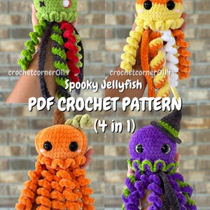 May include: Four plush crochet jellyfish toys featuring a Frankenstein monster, a candy corn, a pumpkin, and a witch design. The text reads crochetcorner0114 Spooky Jellyfish PDF CROCHET PATTERN (4 in 1). Each jellyfish has curly tentacles and black eyes.
