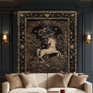 May include: A rectangular wall tapestry featuring a white unicorn in a dark forest setting with floral borders, hanging above a white sofa with beige cushions, a wooden coffee table, and the text Ink & Shadow Fine Art Home Decor.