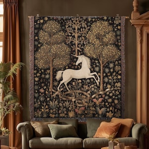 May include: A rectangular woven wall tapestry featuring a white unicorn centred between two trees against a dark black background with floral and botanical details. The text INK & SHADOW Fine Art Home Decor is printed at the bottom of the image.