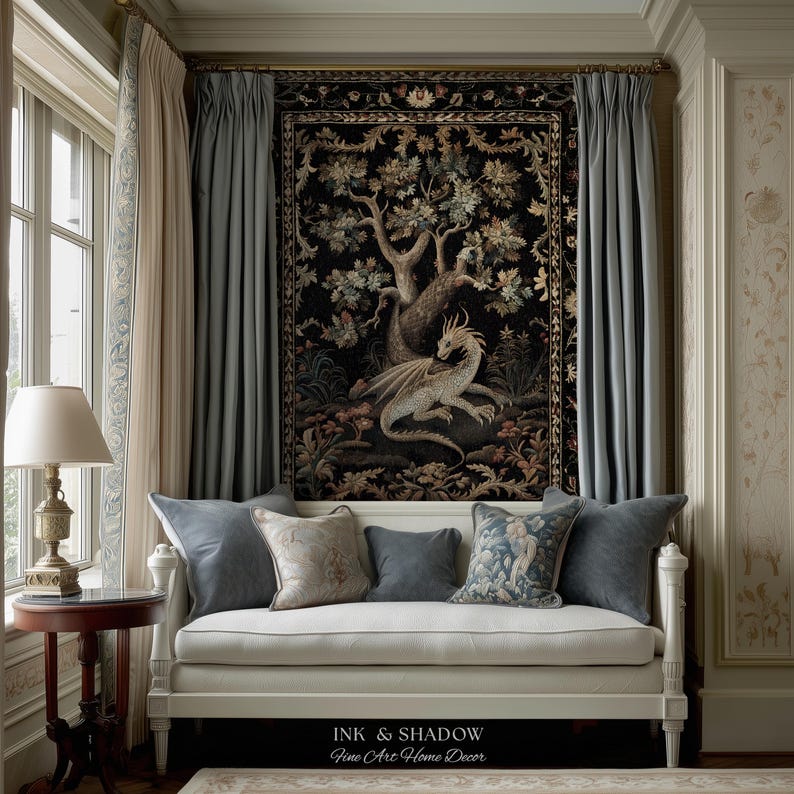 May include: A white daybed with five decorative pillows sits beneath a large black tapestry featuring a detailed dragon and tree motif. The tapestry is framed by light blue curtains. The text INK & SHADOW Fine Art Home Decor is visible.