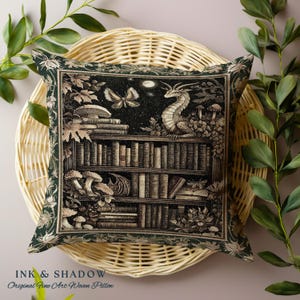 May include: A green throw pillow with a woven tapestry design featuring a bookshelf filled with books, a dragon, mushrooms, and a butterfly. The text "INK & SHADOW Original Fine Art Woven Pillow" is printed at the bottom of the pillow.
