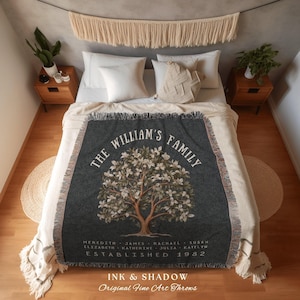 May include: A dark gray throw blanket with a tree design and the text "THE WILLIAM'S FAMILY". The blanket has a fringed edge and includes the names of family members and the year 1982. The words "INK & SHADOW Original Fine Art Throws" are also visible.