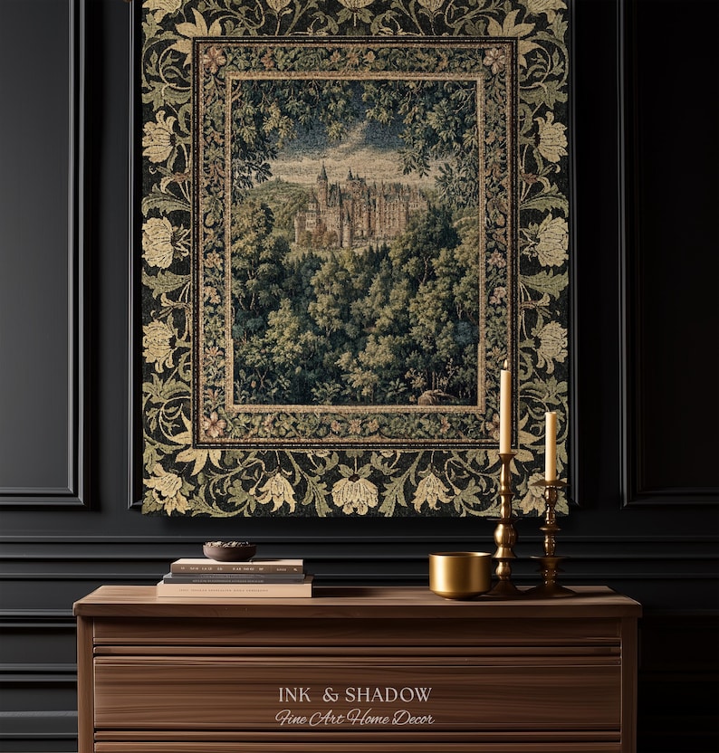May include: A rectangular wall tapestry featuring a detailed woven scene of a castle nestled within a dense forest. The tapestry is framed by a wide, dark border decorated with intricate floral patterns in shades of gold, green, and black.