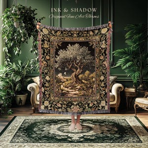 May include: A tapestry throw blanket featuring a detailed landscape scene with a large tree, a crescent moon, and a castle. The throw has a black border with floral and leaf patterns, and the text "INK & SHADOW Original Fine Art Throws".