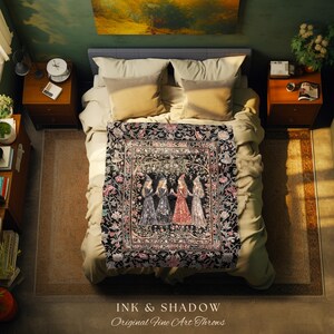 May include: A rectangular throw blanket featuring a central illustration of four figures in pointed hats standing in a circle, surrounded by a detailed floral border with pink and white blossoms on a black background, draped over a bed.