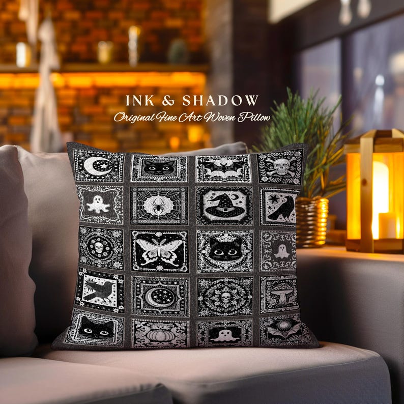 May include: Black and white woven pillow with a Halloween theme. The pillow features a variety of spooky and whimsical designs, including bats, ghosts, spiders, skulls, and a witch's hat. The text "INK & SHADOW Original Fine Art Woven Pillow" is printed on the pillow.