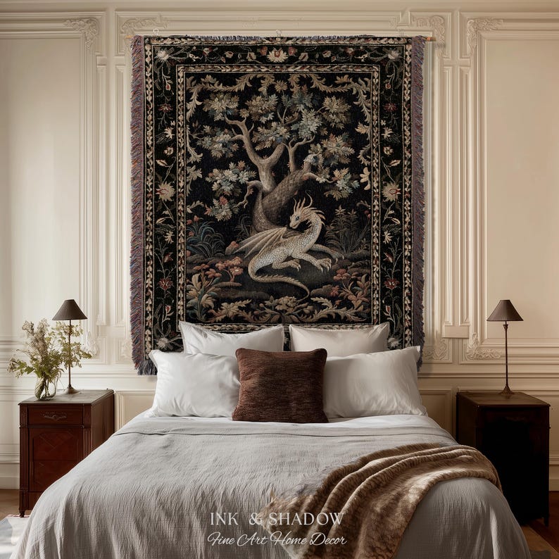 May include: A rectangular woven wall tapestry featuring a central illustration of a light-colored dragon resting beneath a large tree. The design is set against a dark black background with a decorative floral border and fringed edges on the sides.