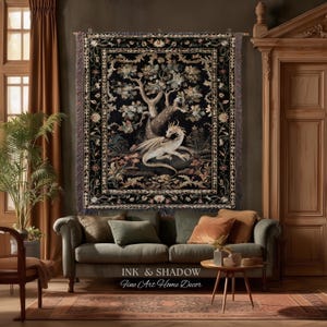 May include: A rectangular woven wall tapestry featuring a central illustration of a white dragon resting beneath a large tree, surrounded by a detailed floral border on a black background, finished with fringed edges along the sides.
