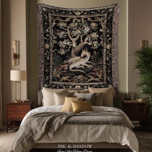 May include: A rectangular woven wall tapestry featuring a central illustration of a white dragon resting beneath a large tree. The design includes a dark black background with intricate floral borders and fringed edges on the sides.