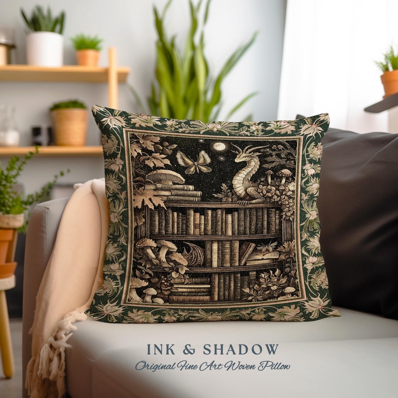 May include: A green woven pillow with a tapestry design featuring a bookshelf filled with books, a dragon, mushrooms, and butterflies. The text "INK & SHADOW Original Fine Art Woven Pillow" is printed below the image.