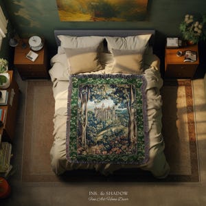 May include: A rectangular woven throw blanket featuring a detailed tapestry-style scene of a castle nestled within a dense forest. The blanket has a dark green border with intricate patterns and a fringed edge, displayed flat on a bed.