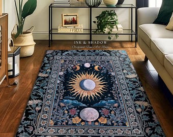May include: A rectangular area rug with a celestial design. The rug features a central sun and moon motif, surrounded by floral and foliate borders in shades of blue, gold, and pink. The text "INK & SHADOW Original Fine Art Rugs" is visible.