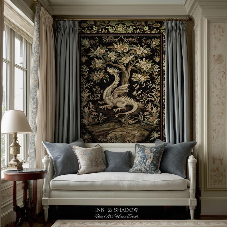May include: A white daybed with five decorative pillows sits beneath a large rectangular wall tapestry featuring a dragon and floral tree motif on a black background. The tapestry is flanked by blue curtains, and the text Ink & Shadow Fine Art Home Decor is visible at the bottom.