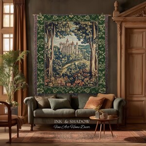 May include: A rectangular woven tapestry featuring a detailed landscape scene of a castle nestled among trees and rolling hills. The tapestry has a dark green border with a floral pattern and is hung on a wooden rod with fringe edges.