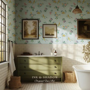 May include: A bathroom scene featuring a green dresser with black hardware, a white countertop, and a white bathtub. The walls are adorned with floral wallpaper and framed artwork. A woven basket and a window are also visible.