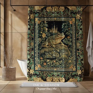 May include: A black and gold shower curtain with a tapestry design featuring a green frog sitting on a rock in a garden setting. The frog is surrounded by flowers and leaves. The text "Ink & Shadow Original Fine Art" is at the bottom of the curtain.