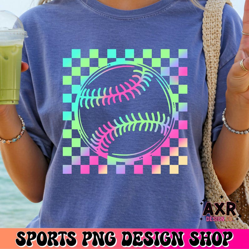 May include: Blue t-shirt featuring a baseball graphic with a checkered background in neon colors. The baseball design is outlined in black and filled with shades of pink, green, and blue. The text "SPORTS PNG DESIGN SHOP" is at the bottom.