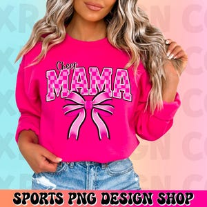May include: A pink sweatshirt with the text "Cheer Mama" in black and white checkered letters and a pink bow.