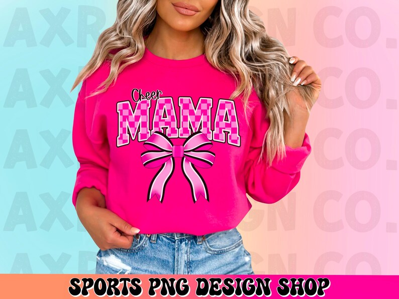 May include: A pink sweatshirt with the text "Cheer Mama" in black and white checkered letters and a pink bow.