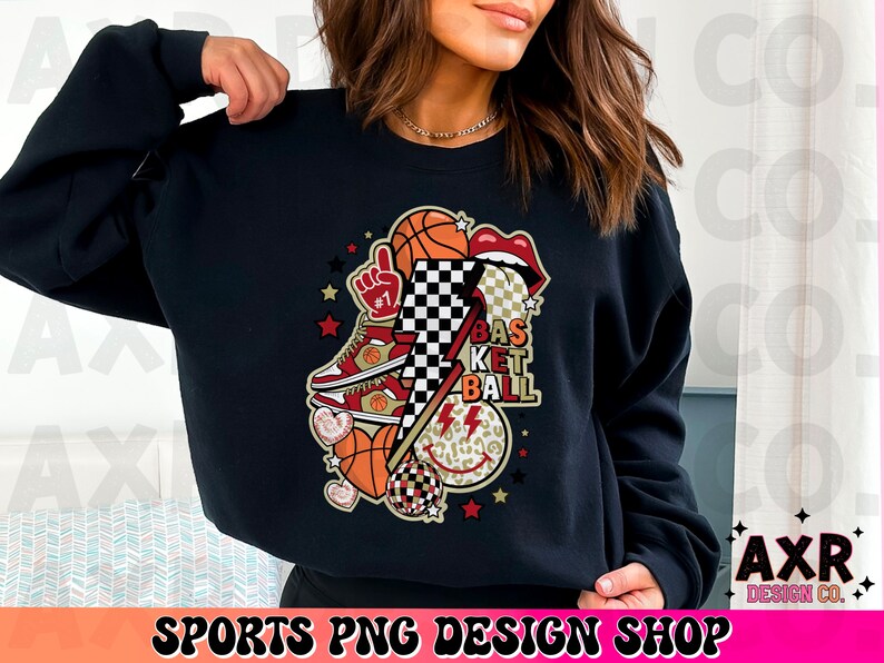 K&ouml;nnte beinhalten: Schwarzes Sweatshirt mit einem Basketball-Motiv. Das Design umfasst Basketb&auml;lle, einen Turnschuh, Lippen, einen Blitz und die Worte "Basketball". Das Design enth&auml;lt auch ein Schachbrettmuster und Sterne.