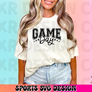 May include: A white t-shirt with black text that reads "GAME Day" with stars around the word "Day".
