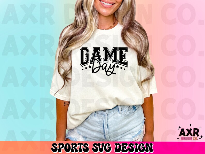 May include: A white t-shirt with black text that reads "GAME Day" with stars around the word "Day".