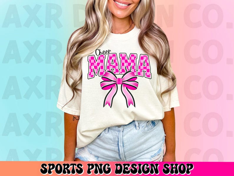May include: A white t-shirt with the text "Cheer Mama" in pink and black checkered letters. A pink bow with a checkered pattern is below the text.