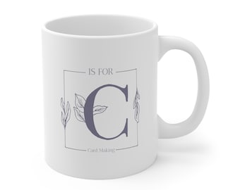 May include: White ceramic mug with a purple letter C and floral design. The text "C is for Card Making" is printed on the mug.