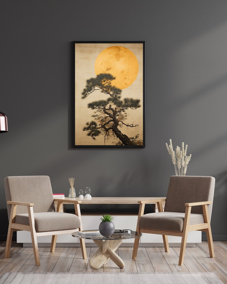 May include: A framed print of a stylized Japanese landscape with a large yellow moon and a dark green pine tree. The print is hanging on a dark gray wall above a wooden coffee table with two chairs.
