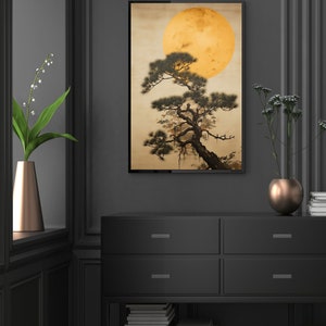 May include: A framed print of a stylized Japanese painting featuring a dark green pine tree with a large, yellow moon in the background.