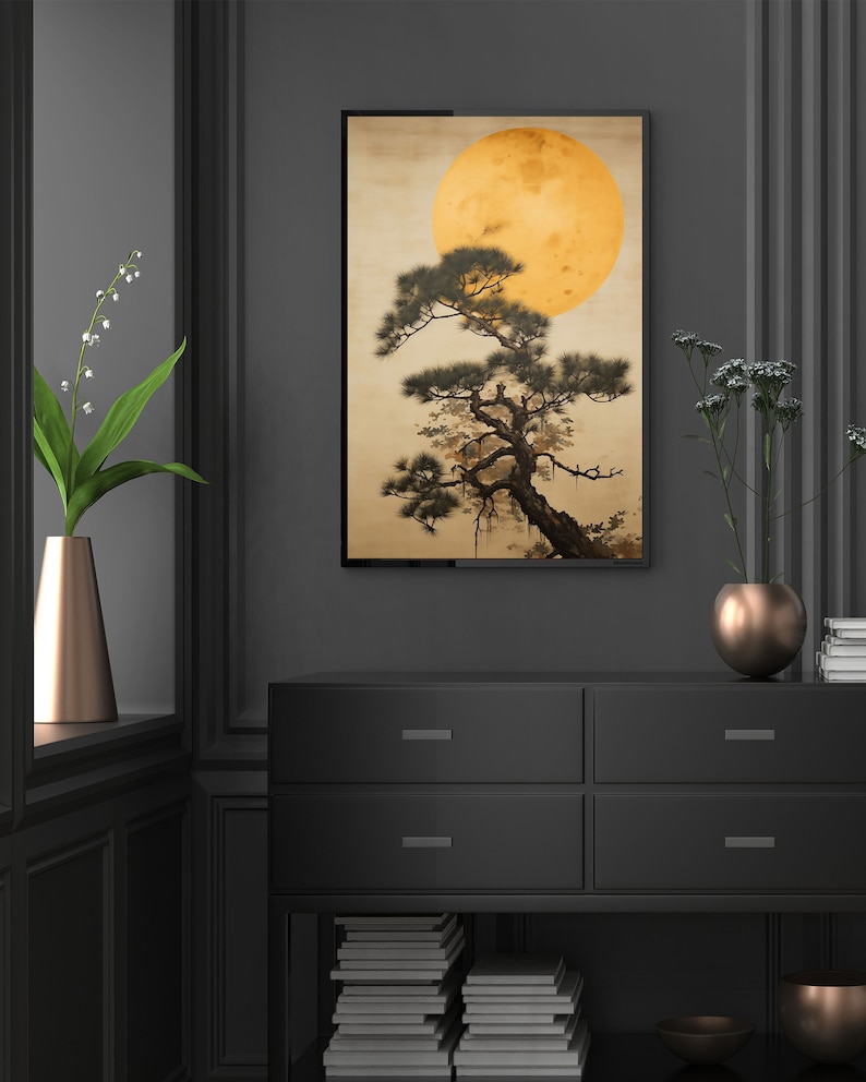 May include: A framed print of a stylized Japanese painting featuring a dark green pine tree with a large, yellow moon in the background.