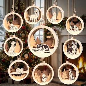 May include: A collection of nine circular wooden ornaments featuring laser-cut dog silhouettes and forest landscapes. Each ornament is suspended by a string and displays a different dog breed, including a husky, corgi, and labrador, set against trees.