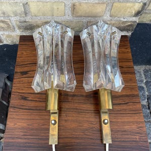 A pair of Danish retro wall lamps in brass and pressed glass from the 1970s