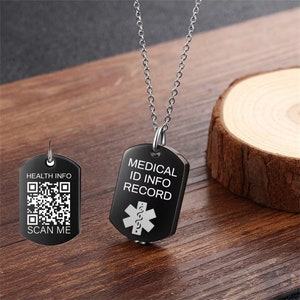 May include: Black medical ID necklace with a silver chain. The pendant has a black background with white text that reads "MEDICAL ID INFO RECORD" and a white medical symbol. The back of the pendant has a QR code and the text "HEALTH INFO SCAN ME".