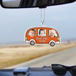 May include: Orange cartoon car rearview mirror charm with three children's faces in the windows. The car has the text "Drive Safe Daddy" on the bottom.