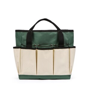 May include: A green and beige garden tool tote bag with multiple exterior pockets. The bag has a black handle and trim, and is designed to hold gardening tools. The bag is made of durable fabric and is designed for outdoor use.