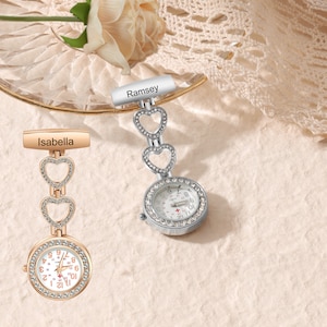 May include: Two silver and gold tone jeweled pocket watches with heart-shaped charms. The watches have personalised name tags that read "Ramsey" and "Isabella".