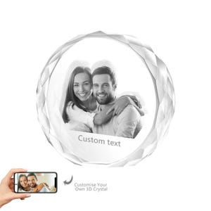 May include: A round, clear crystal with a black and white photo of a couple inside. The crystal has a faceted design and the text "Custom text" is engraved on the bottom.
