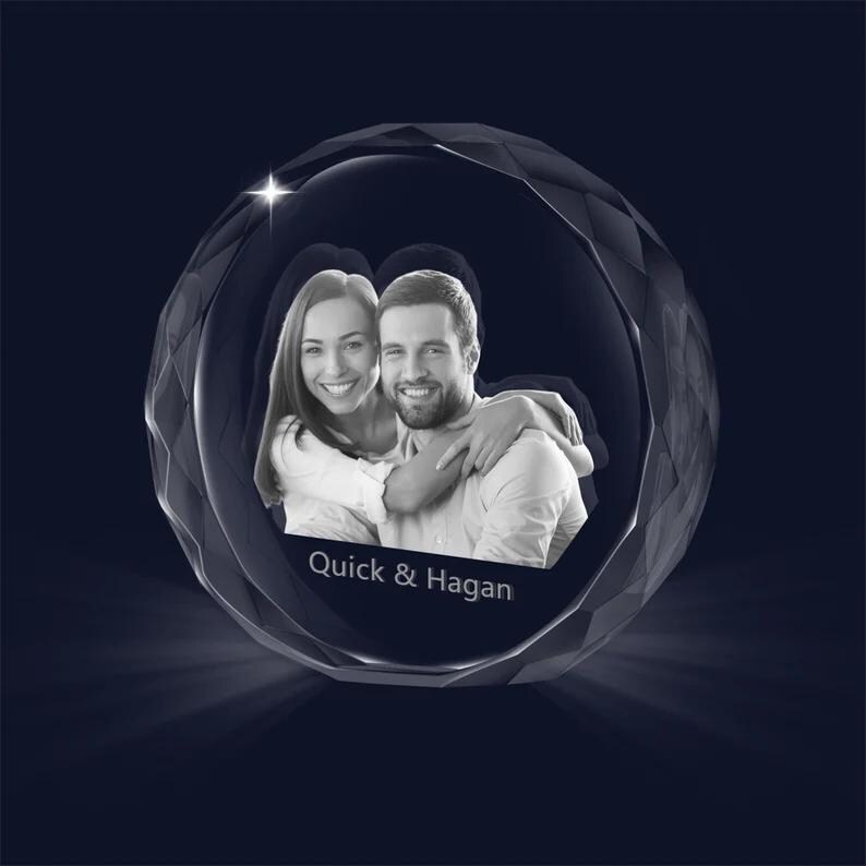 May include: A crystal sphere with a black and white photo of a couple inside. The sphere is faceted and has a reflective surface. The text "Quick & Hagan" is printed on the sphere.