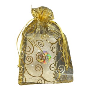 May include: A gold organza gift bag with a gold swirl pattern. The bag is tied with a gold ribbon.